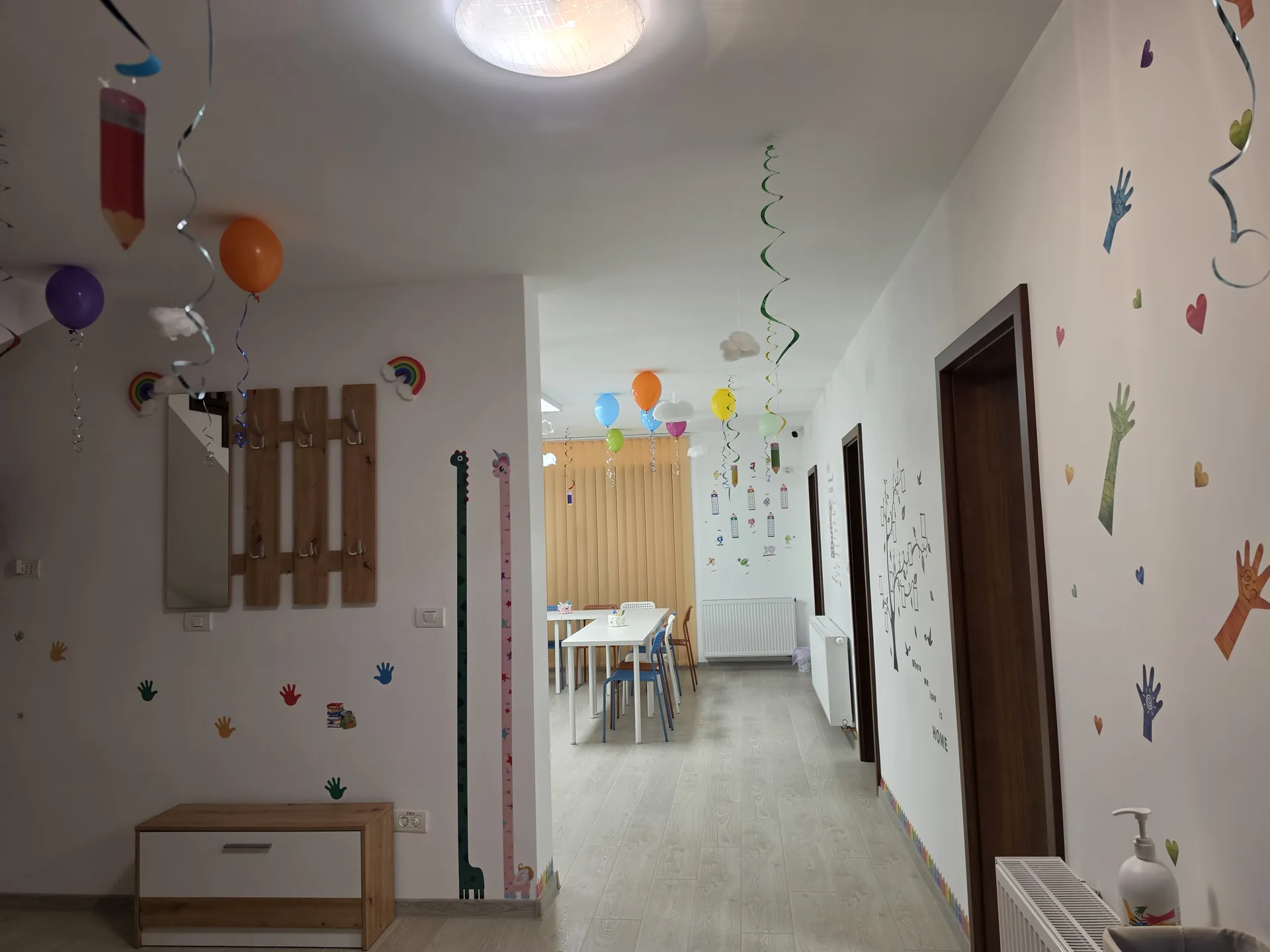 Holul de acces către sălile de clasă, cu pereți decorați cu autocolante colorate
